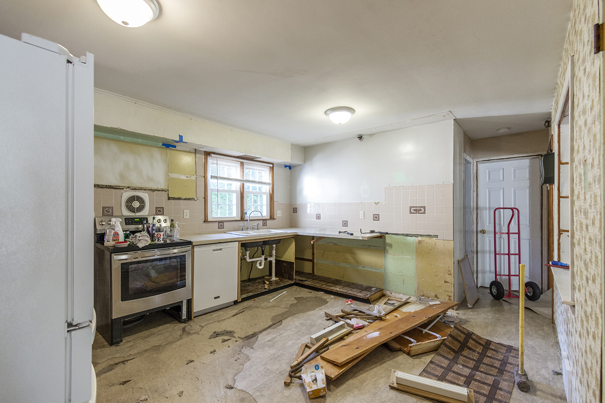 Before kitchen remodeling in Bethel CT showing original kitchen cabinets, flooring, countertops, and layout before renovation